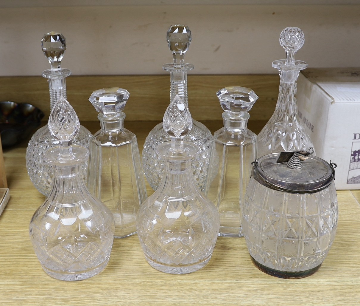 A pair of hobnail cut decanters two other pairs of cut glass decanters a single decanter and a glass and plate biscuit barrel